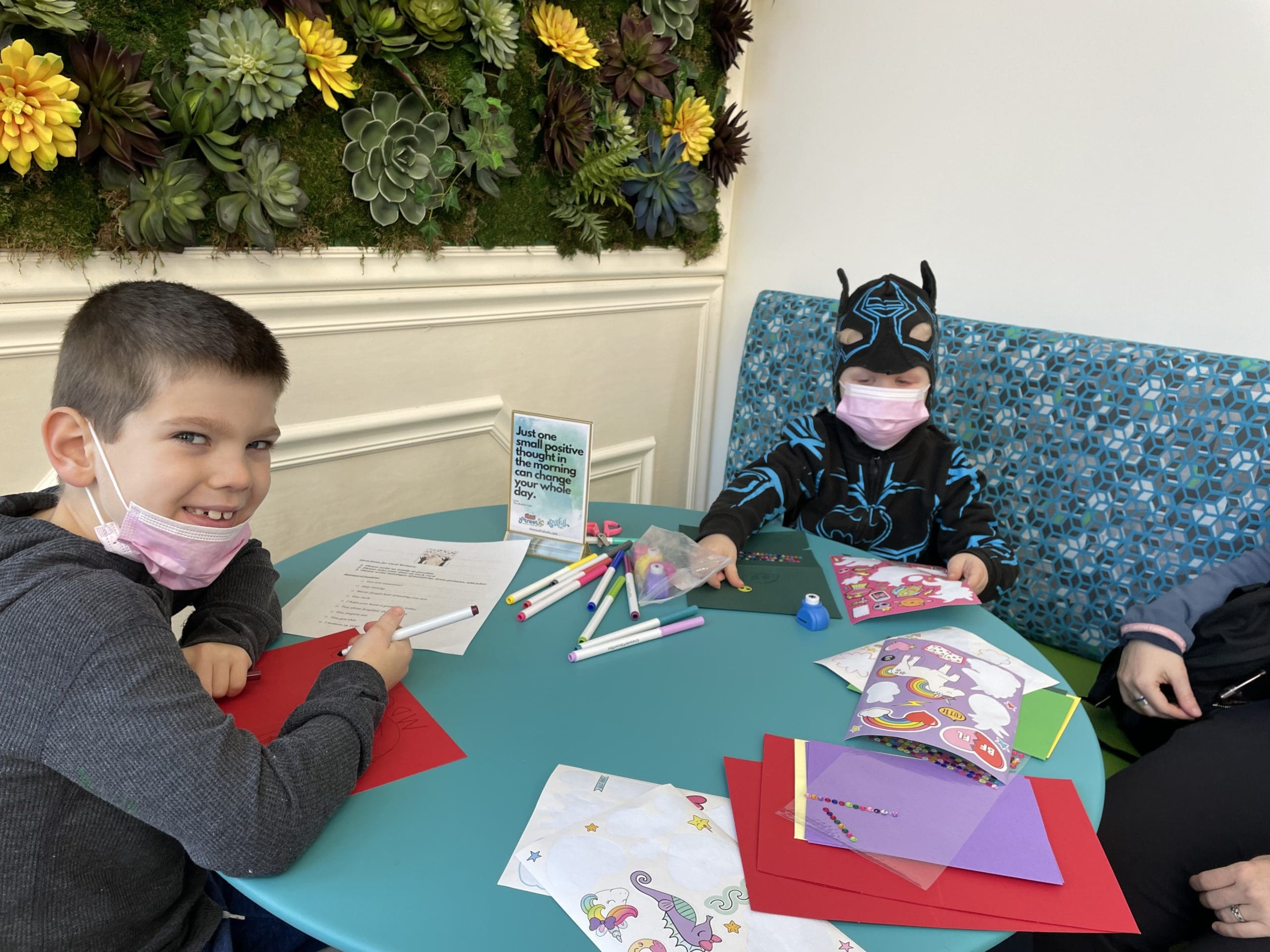 Two young boys making cards in Soulfull Cafe.