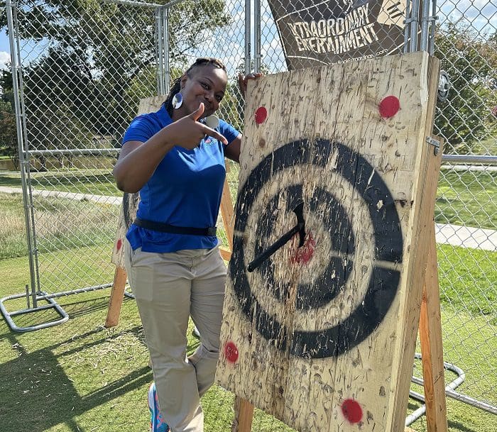 Main Street Connect staff member gets a bullseye when axe throwing at the 2023 Main Street Golf Outing
