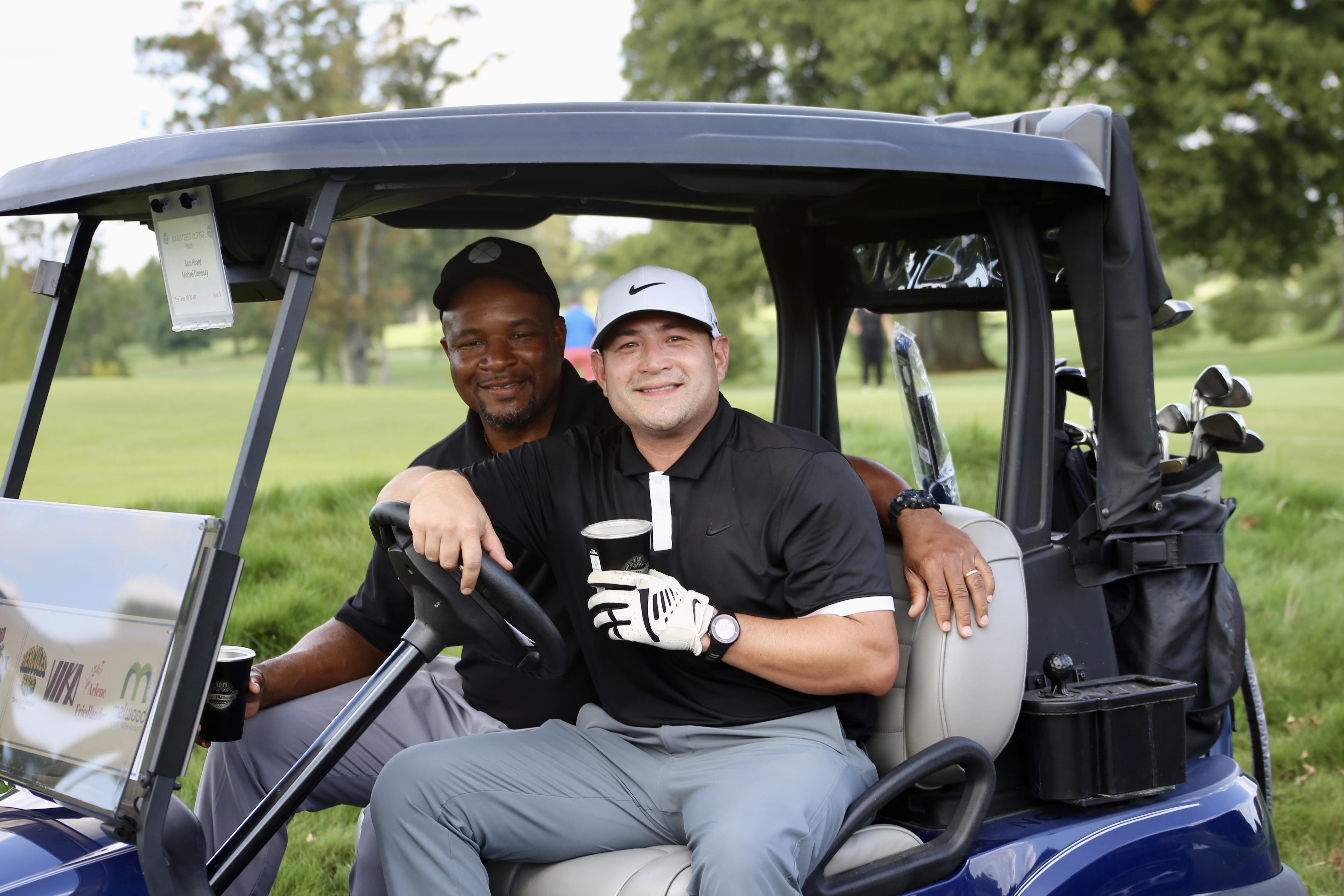 Two golfers in golf cart at Main Street's 2023 Golf Outing
