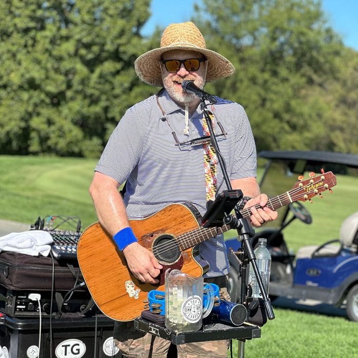 Guitar player at the 2023 Main Street Connect Golf Outing