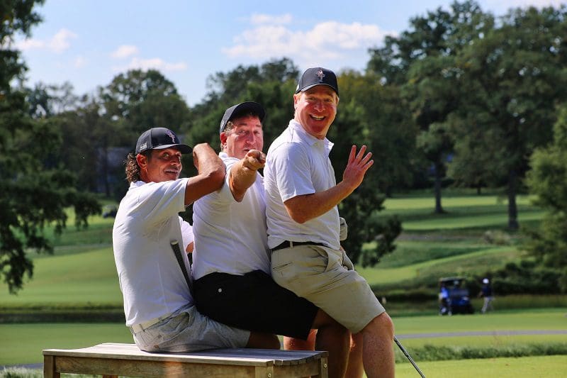 Three golfers posing for a funny photo at the 2023 Main Street Golf Outing