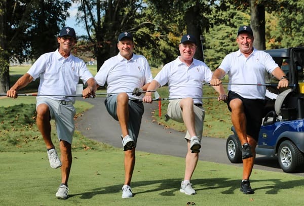 Four golfers with clubs at Main Street's 2023 Golf Outing