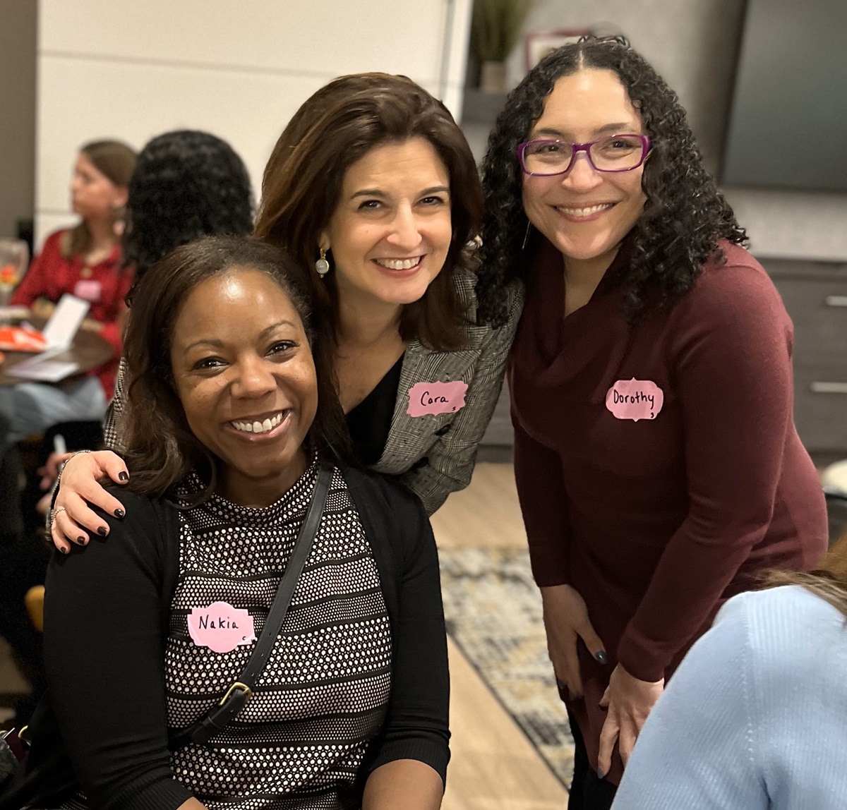 Three women smiling at Main Street Galentine's Professional Event