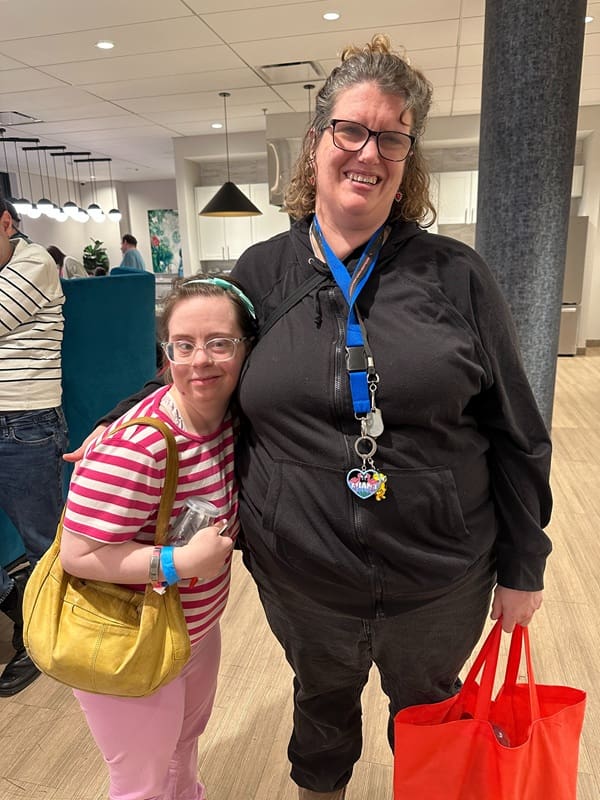 Main Street ambassador and member with arms around each other