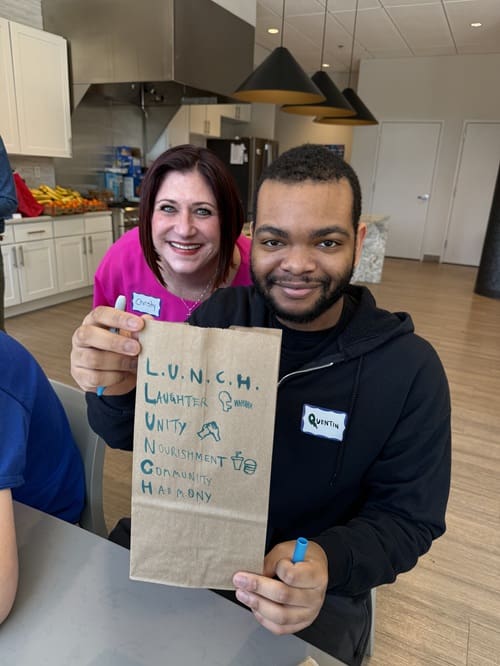 Decorating lunch bags during collaborative service event