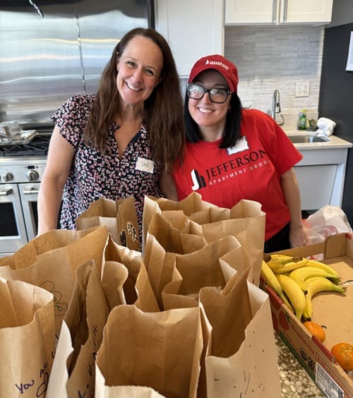 Stuffing lunch bags during a collaborative service event at Main Street
