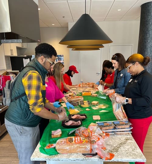 Making sandwiches during a collaborative service event at Main Street